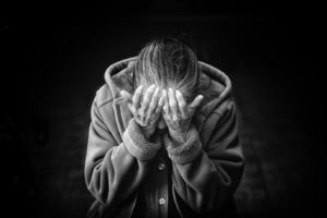 A black-and-white photo of a crying woman